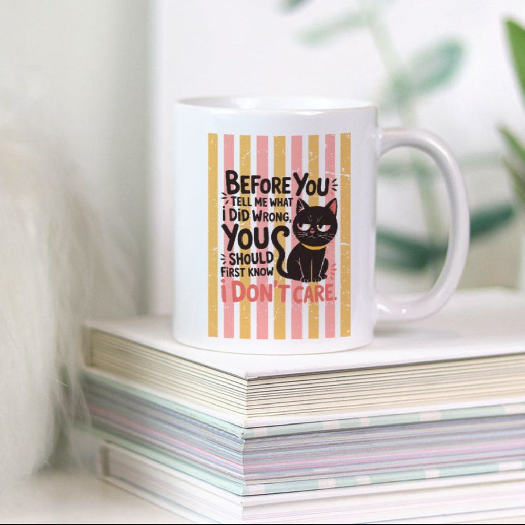 11oz Mug with a black cat illustration and text on a stack of books with a plant in the background