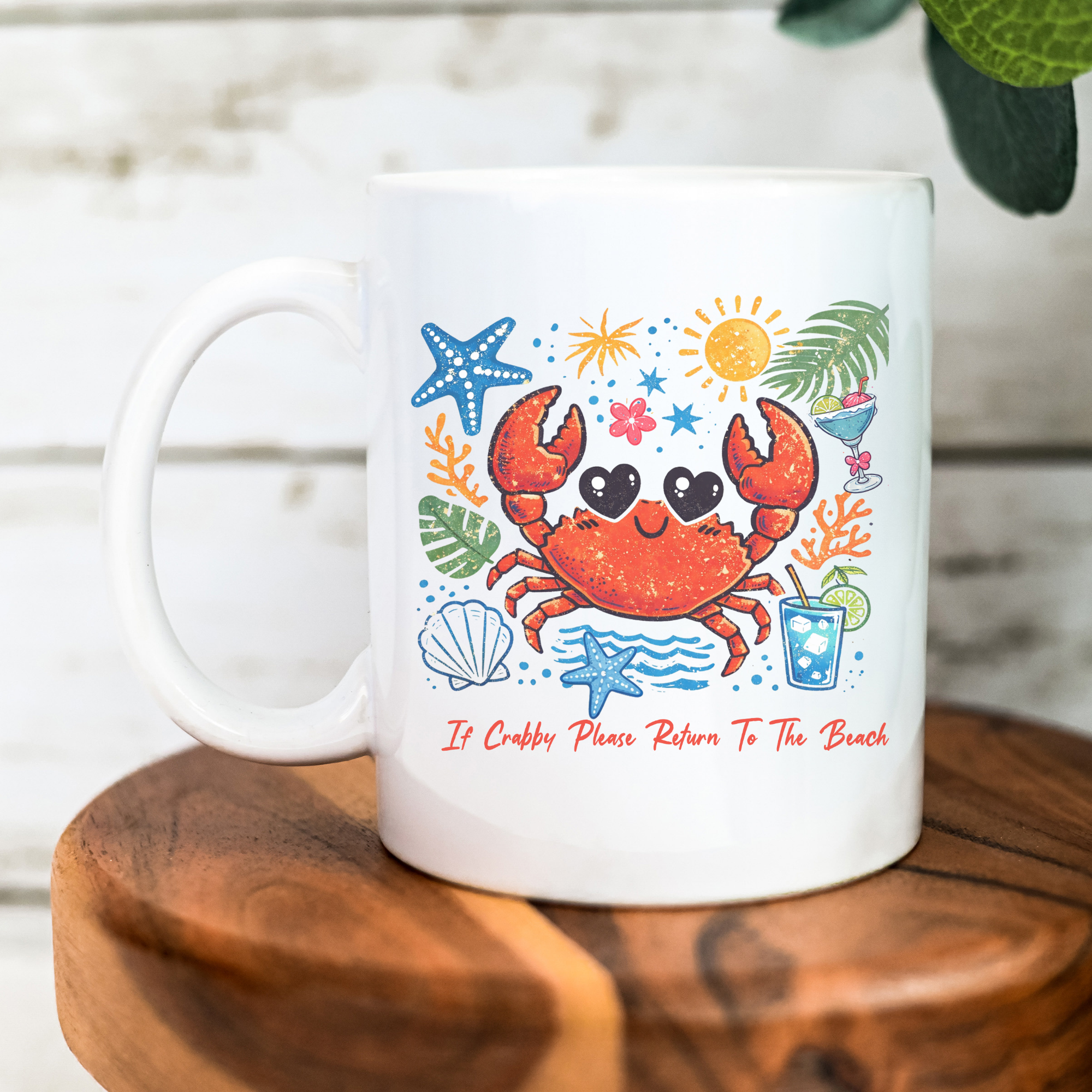 11oz. White mug with a colorful crab design and text on a wooden surface.
