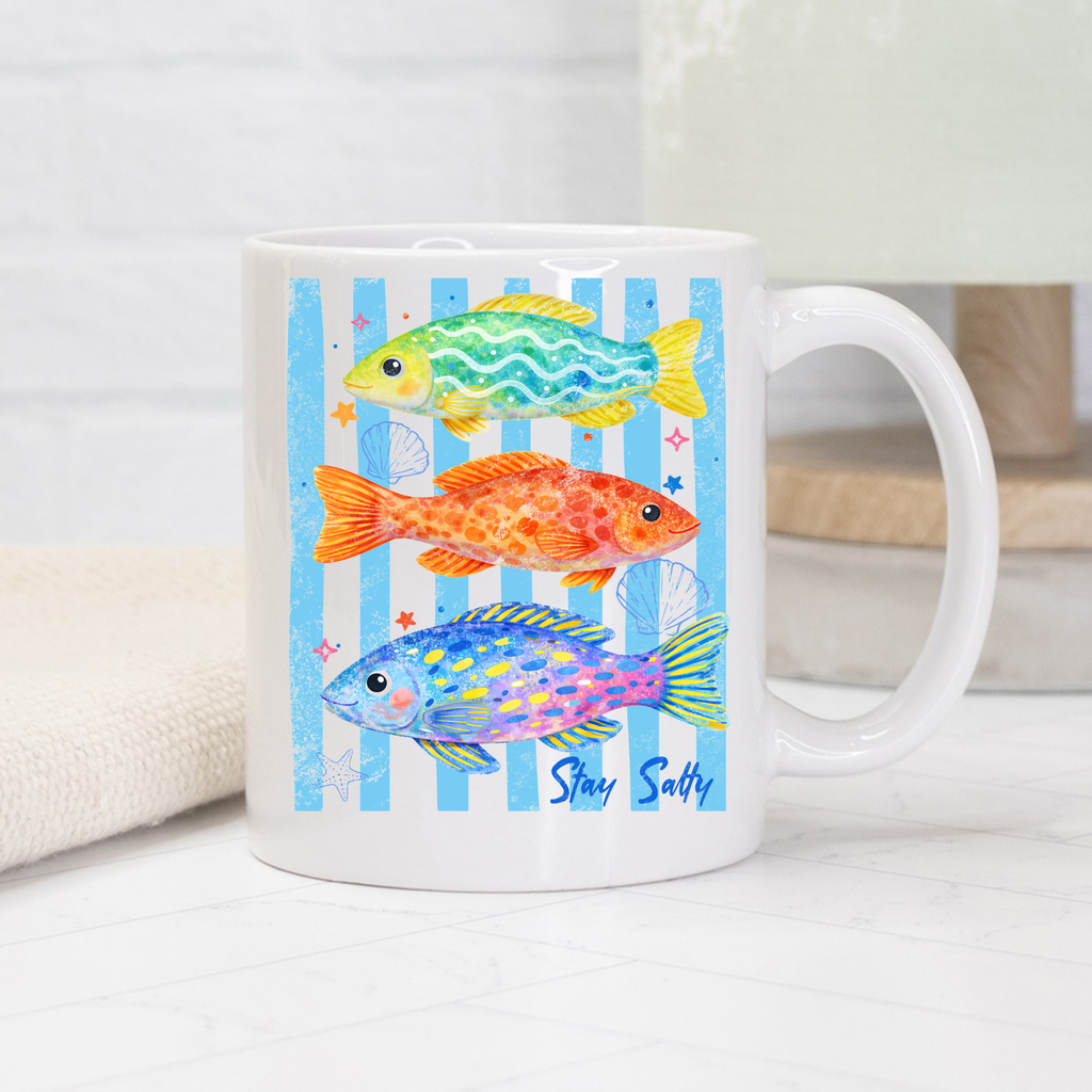White mug with colorful fish design and 'Stay Salty' text on a white background
