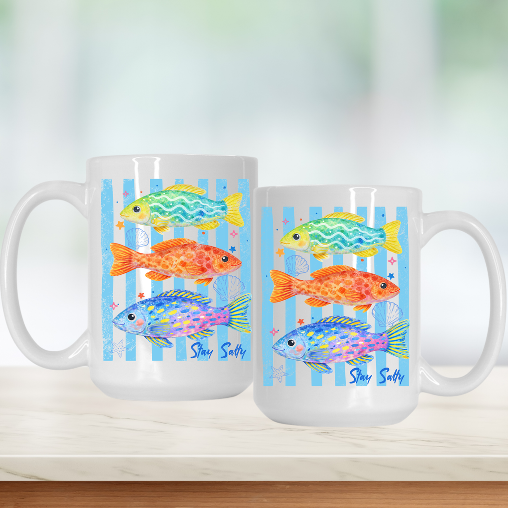 Two mugs with colorful fish design on a white surface