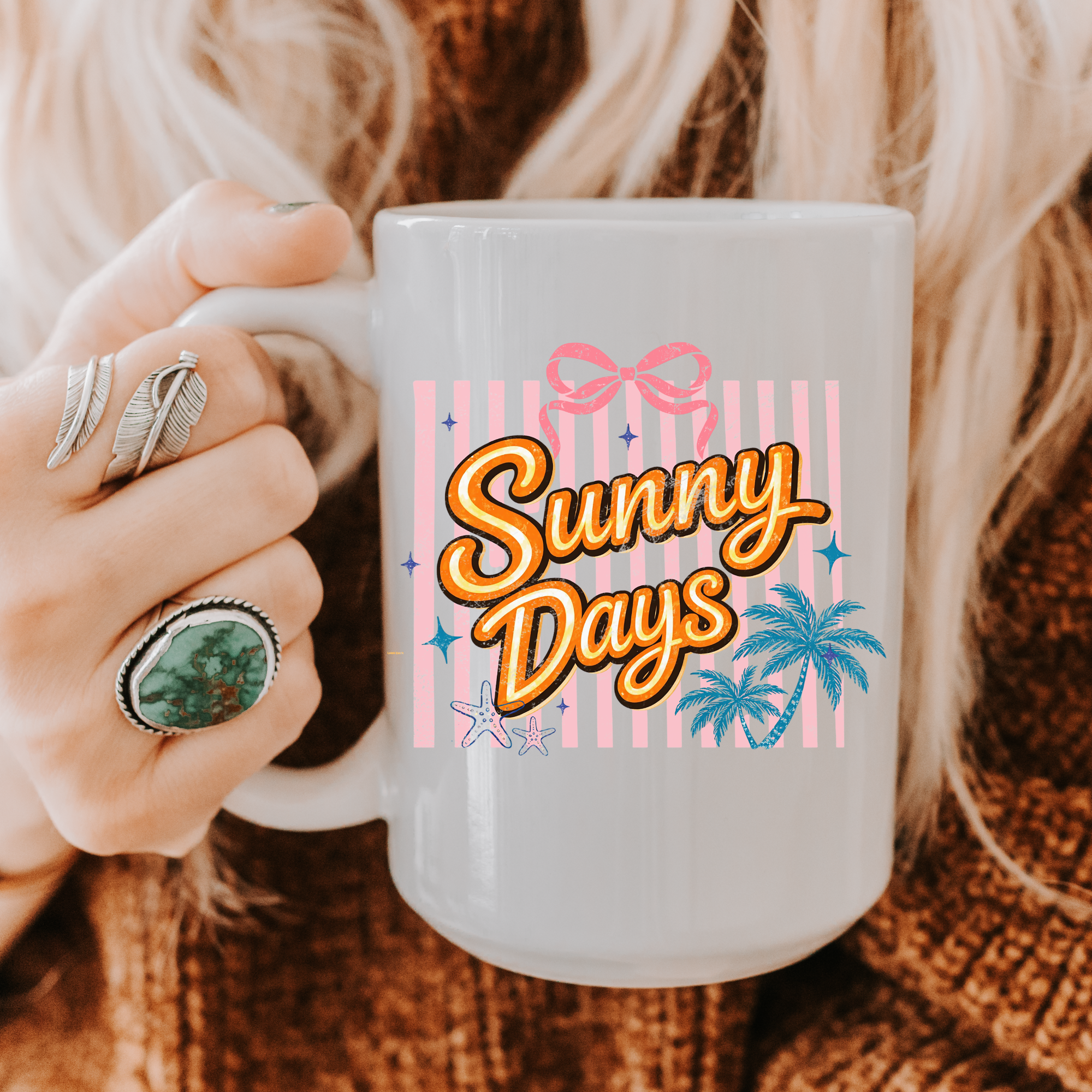 Person holding a 15oz. mug with 'Sunny Days' design, surrounded by cozy textures