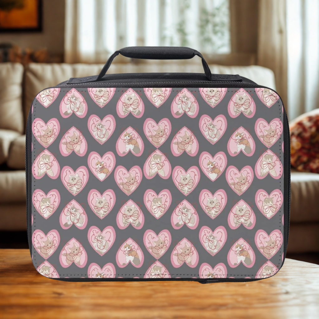 insulated lunch bag with hand drawn cats inside of hearts pattern on a wooden coffee table in a cozy living room.