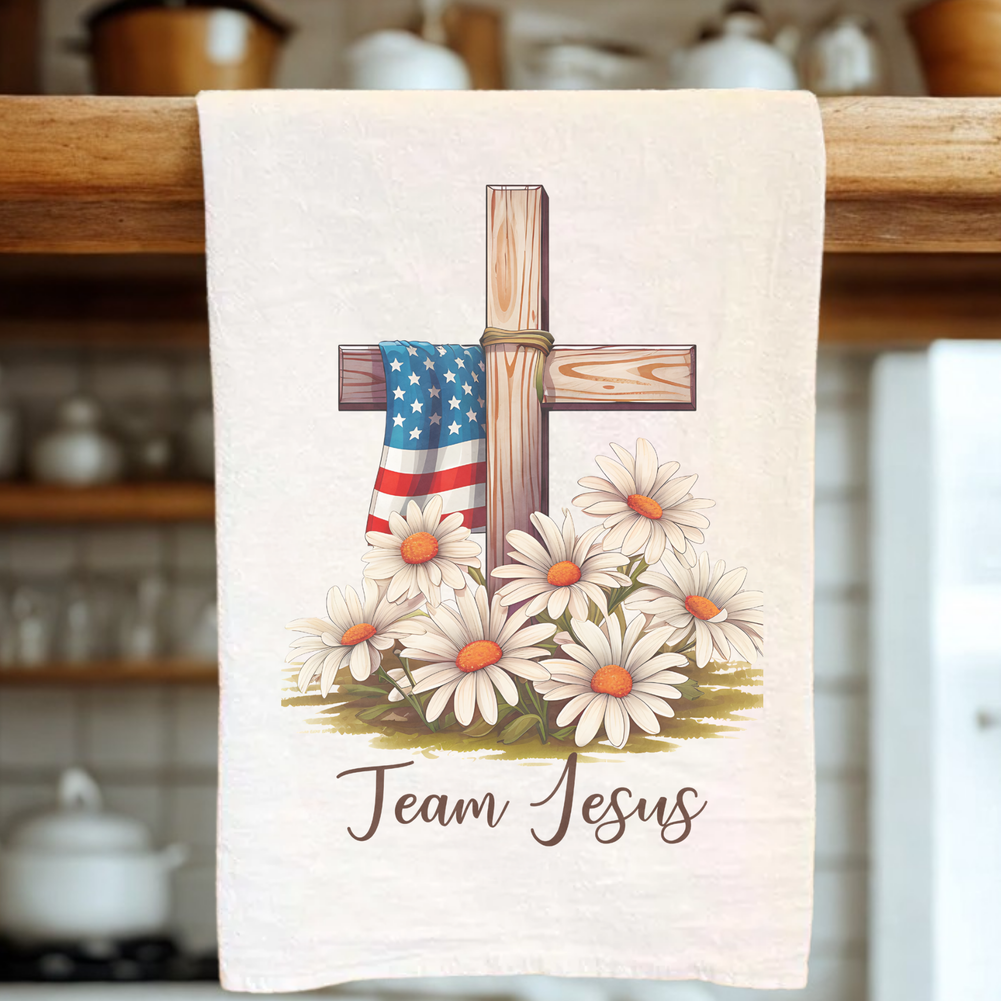 Extra Large Tea Towel with a cross, American flag, flowers, and text ' Team Jesus' design on a wooden rack.