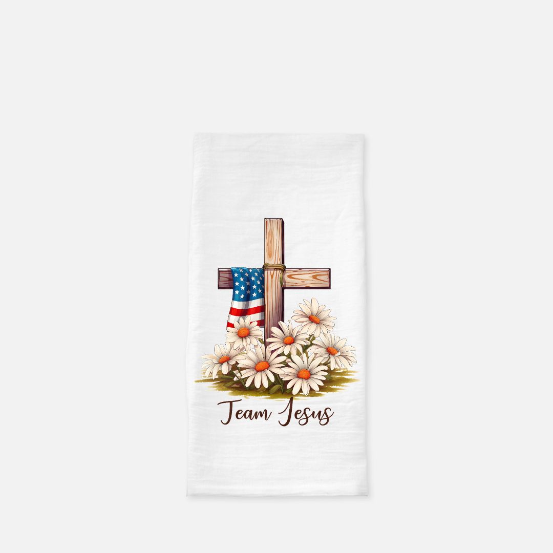 Folded tea towel with cross, American flag, and flowers on a white background