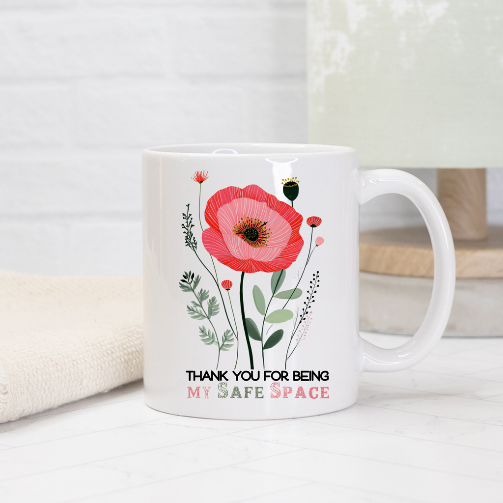 White 11oz mug with a red flower design and text on a white background 