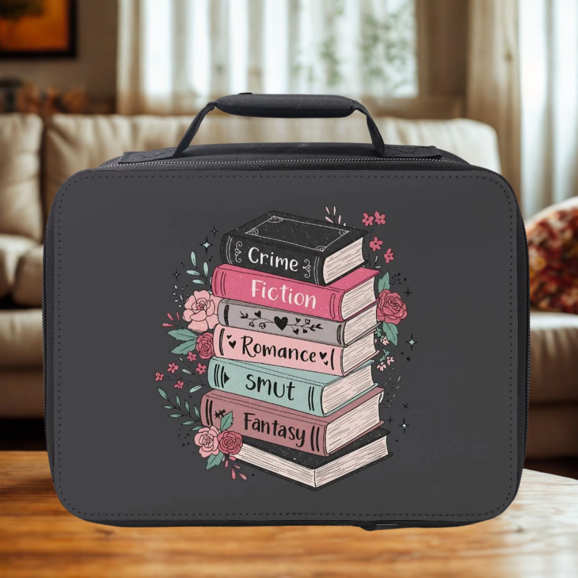 Black insulated lunch bag with book design and text on a wooden surface.