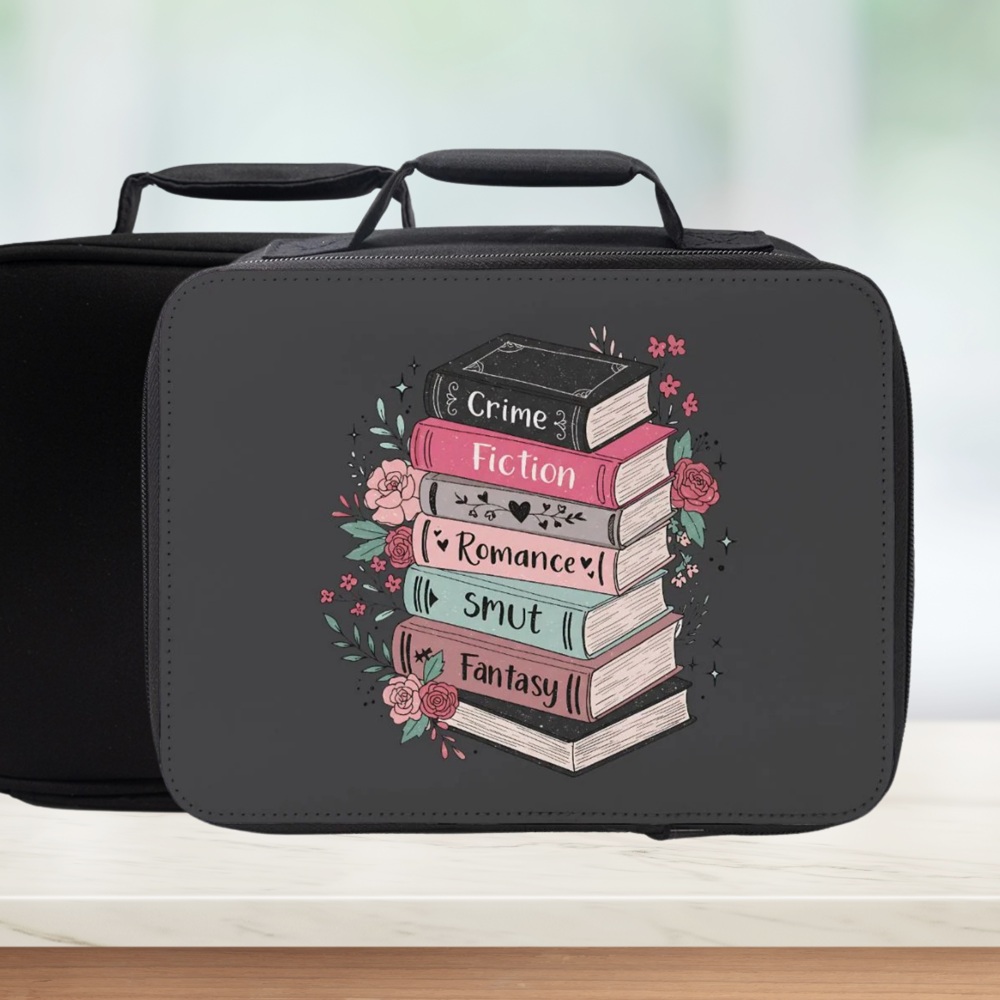 Black lunch bag with book stack design and text on a white surface