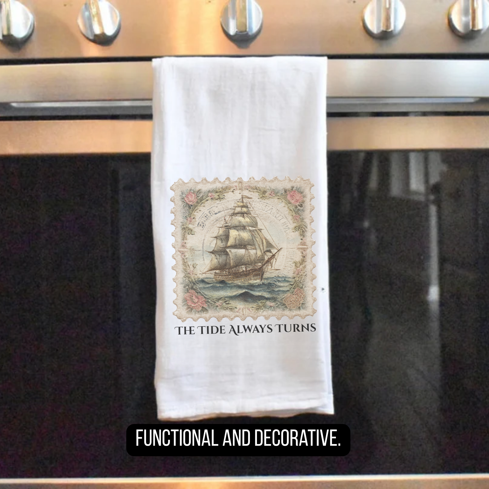 Decorative tea towel with ship design and text ' The Tide Always Turns' hanging on a stove handle