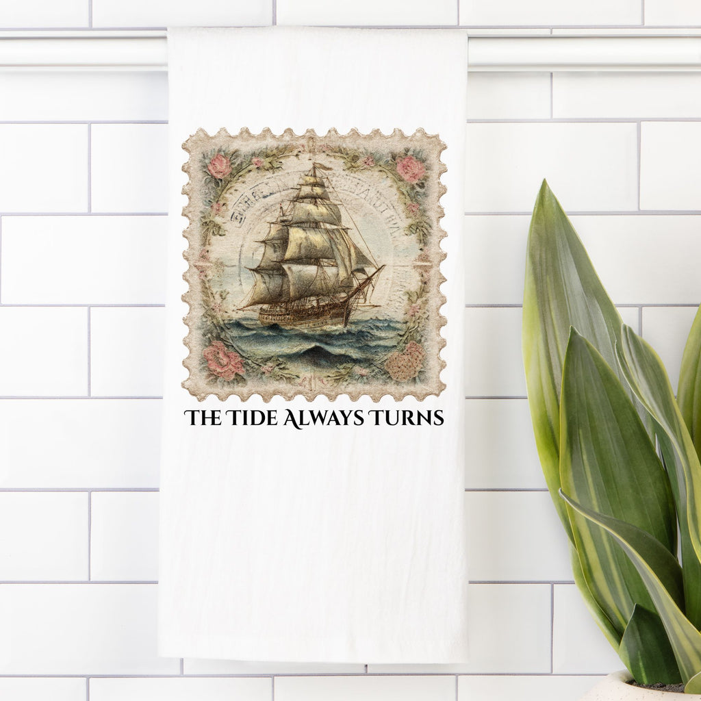 Decorative tile with a ship design and text 'The Tide Always Turns' on a white tiled wall.