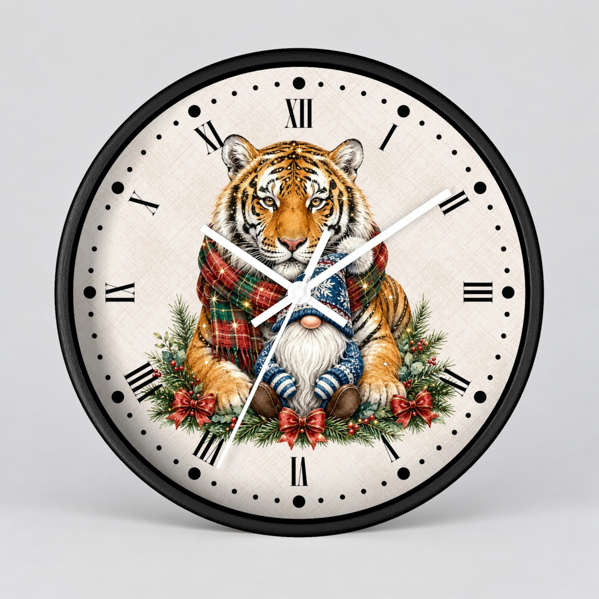 Round wall clock with a black frame and a festive illustration of a tiger wrapped in a red plaid scarf, seated among green pine branches and red bows on an off-white face with black Roman numerals.