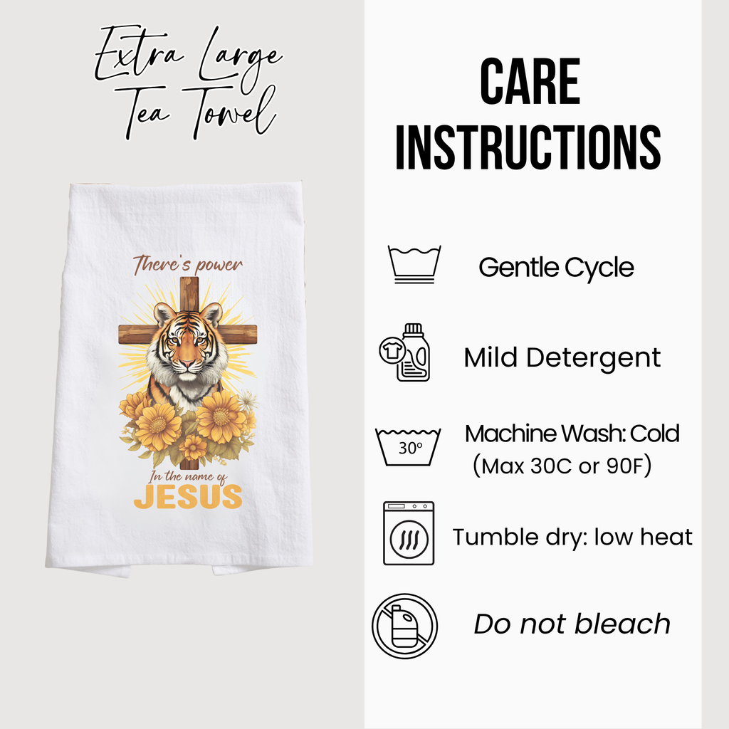 Tea towel with tiger and cross design, care instructions displayed.