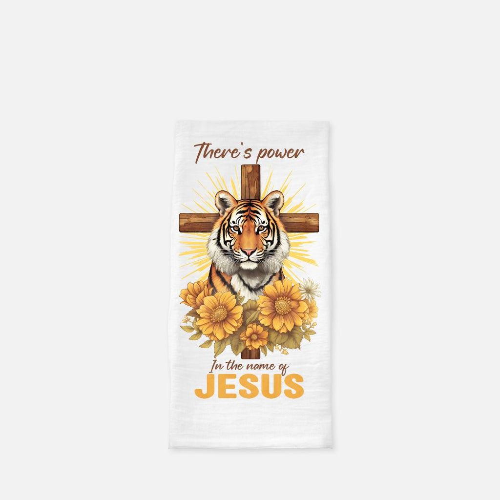 Tea towel with a tiger, cross, and flowers design on a white background