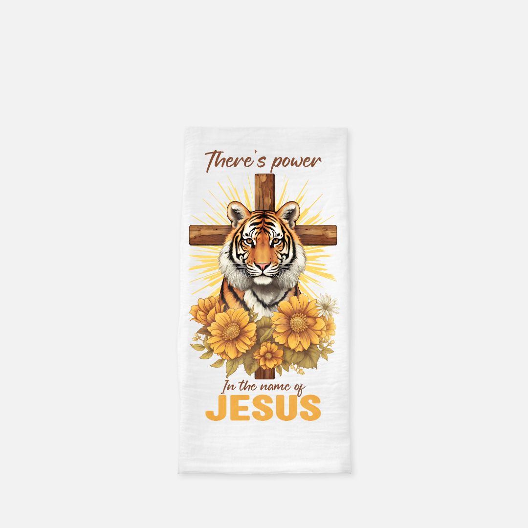 Tea towel with a tiger, cross, and flowers design on a white background