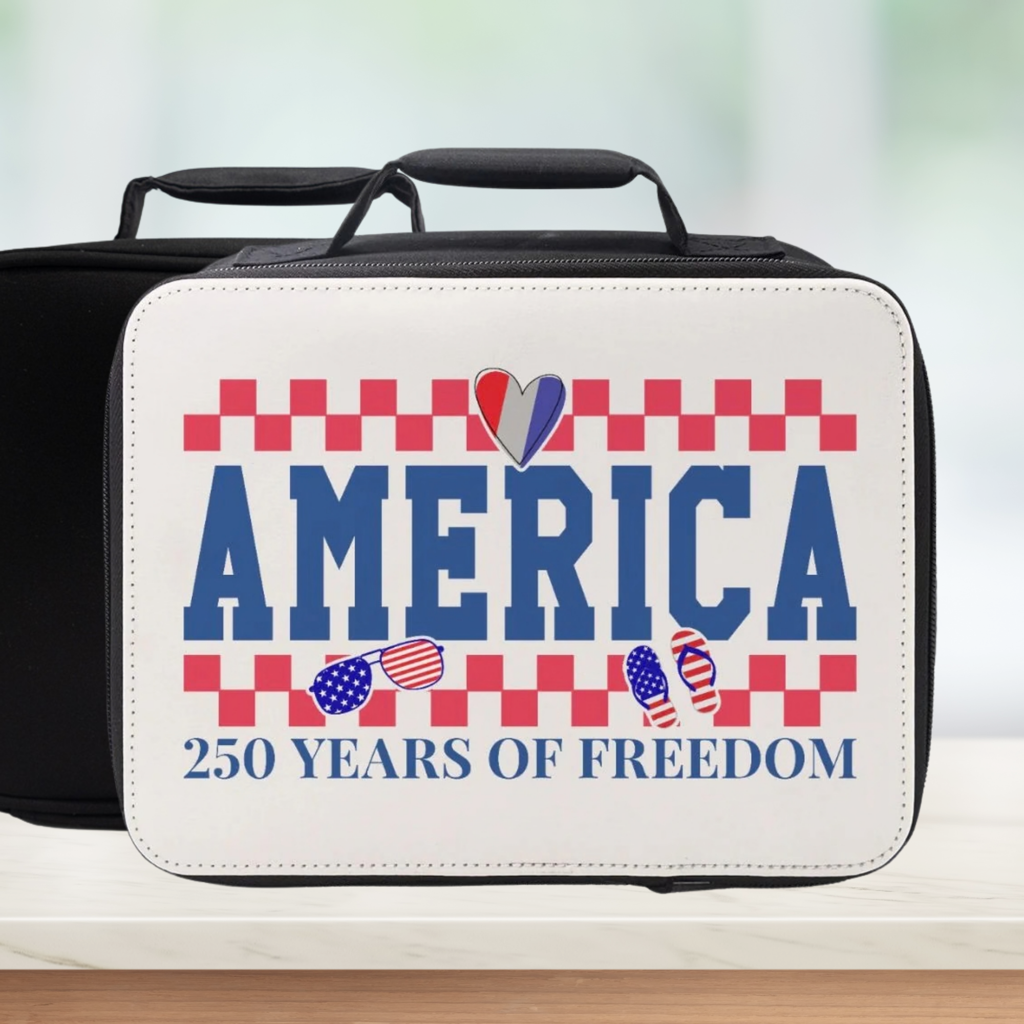 Insulated lunch bag with 'America 250 Years of Freedom' text and patriotic graphics on a blurred background.