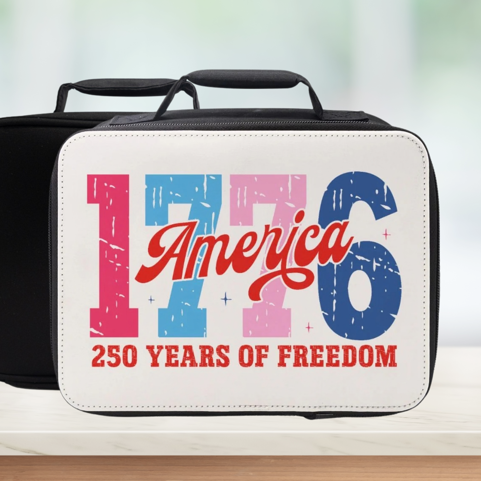 White lunch box with '1776 America 250 Years of Freedom' text on a blurred background