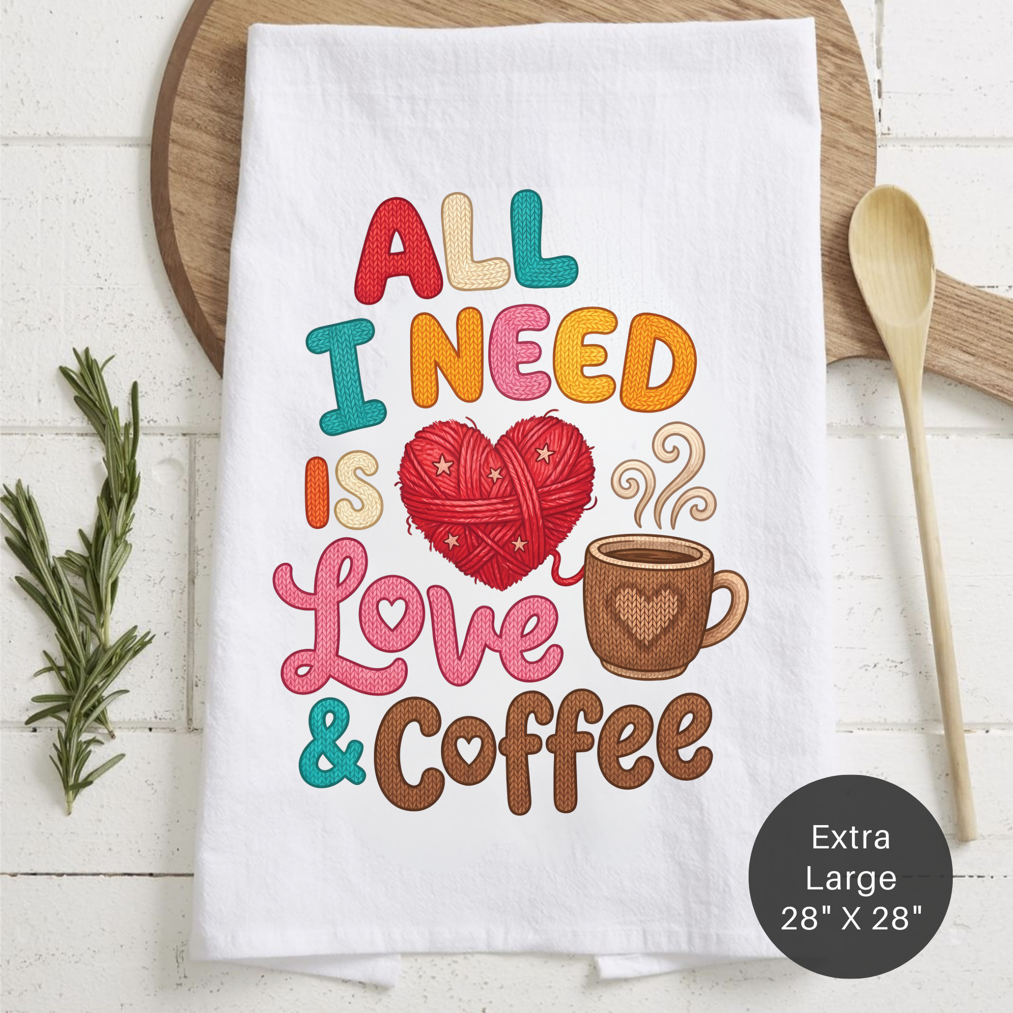White tea towel with colorful text and graphics on a wooden surface