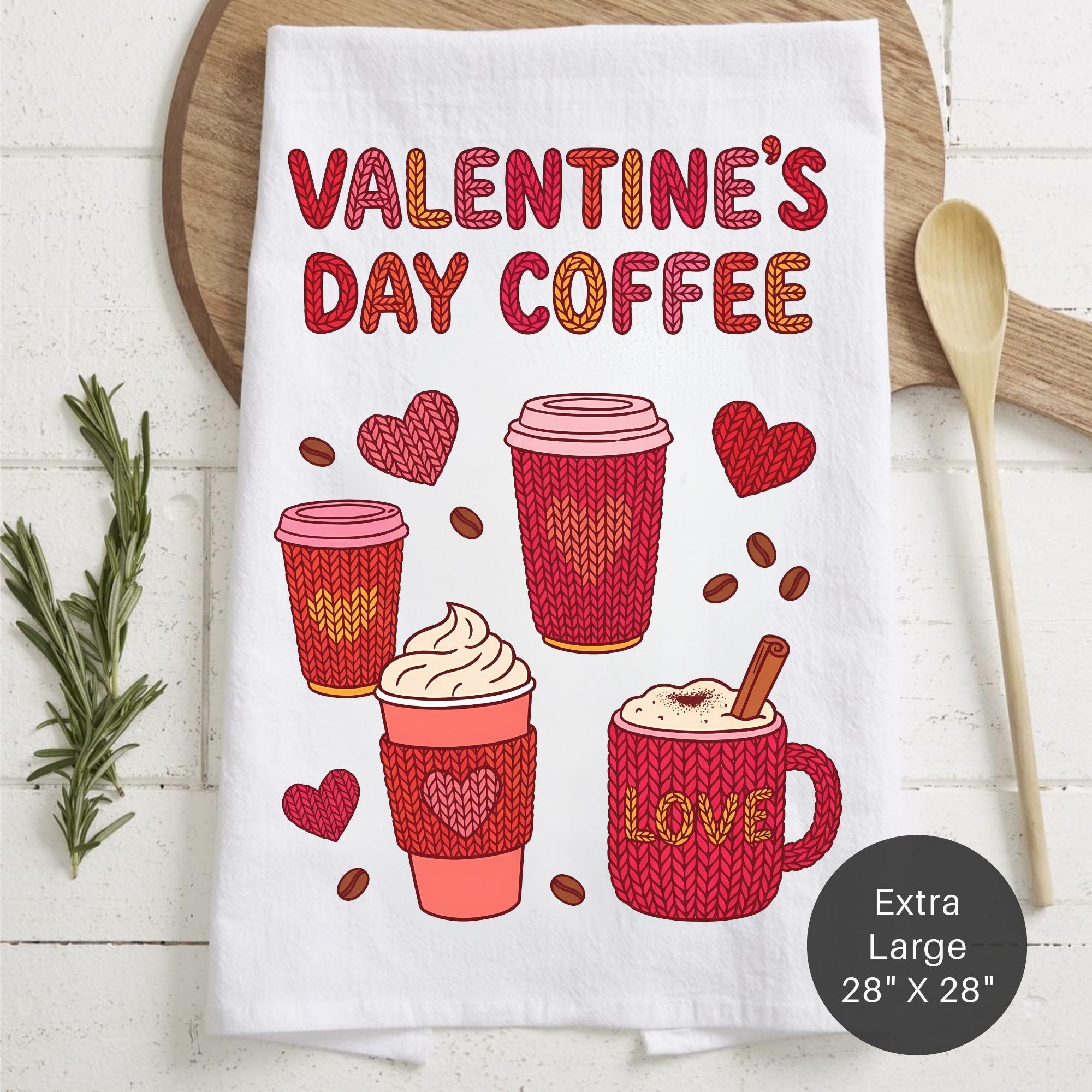 Valentine's Day-themed kitchen towel with coffee cups and hearts on a wooden surface.