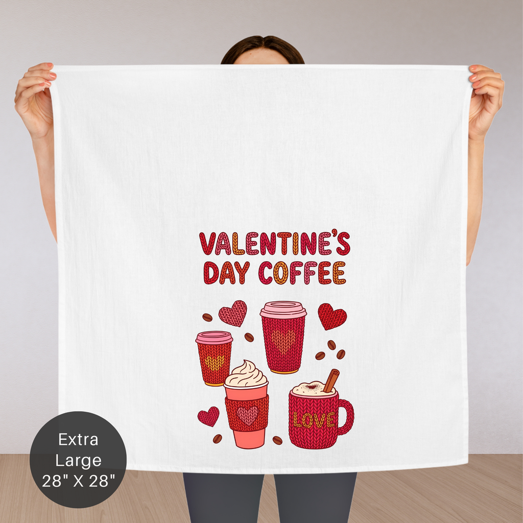 Person holding an extra large tea towel with Valentine's Day coffee design.