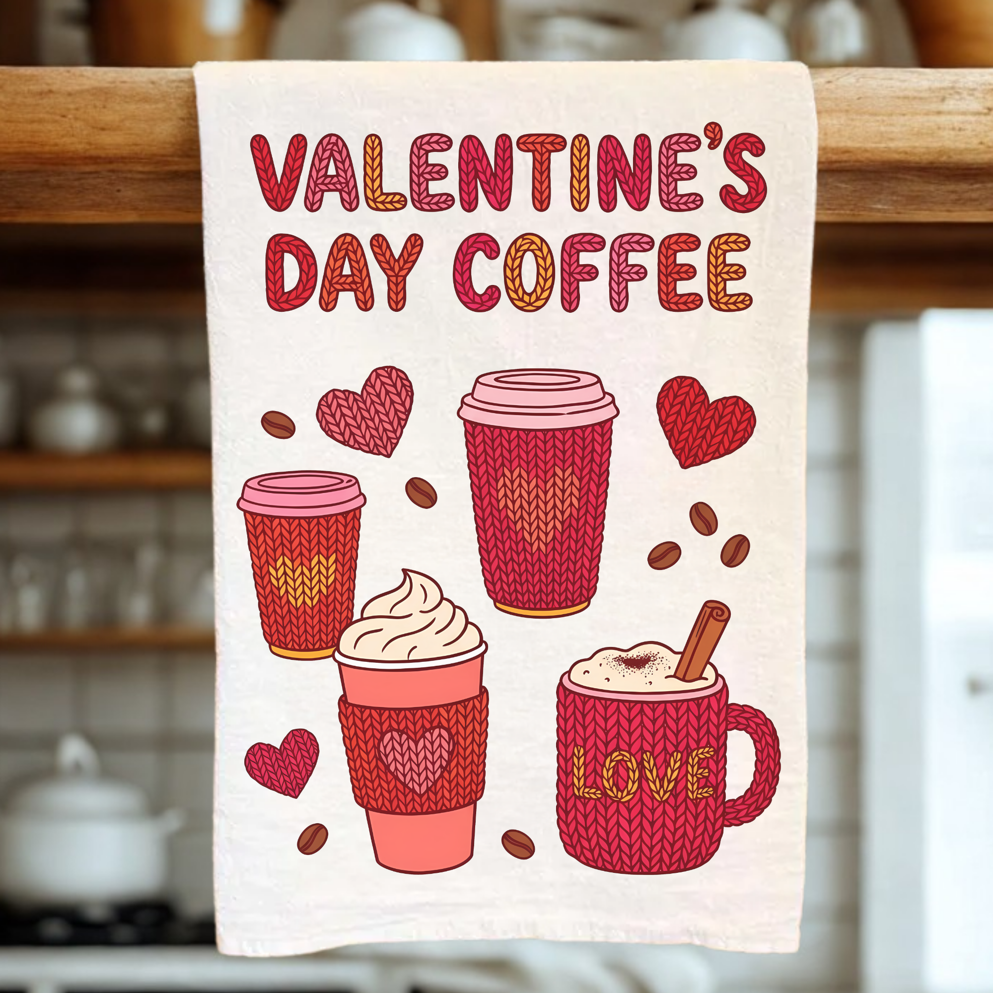 Valentine's Day coffee-themed tea towel with illustrations of coffee cups and hearts on a wooden rack.