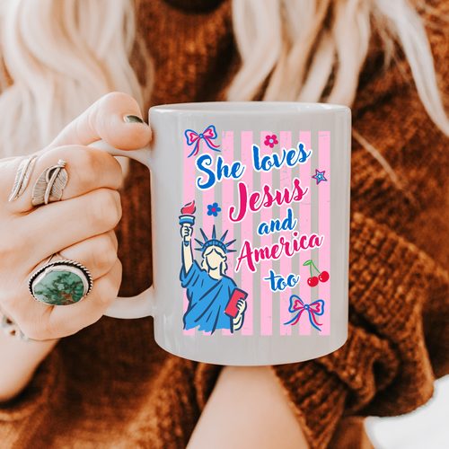 Person holding a 11oz. mug with a colorful design and text, wearing rings.
