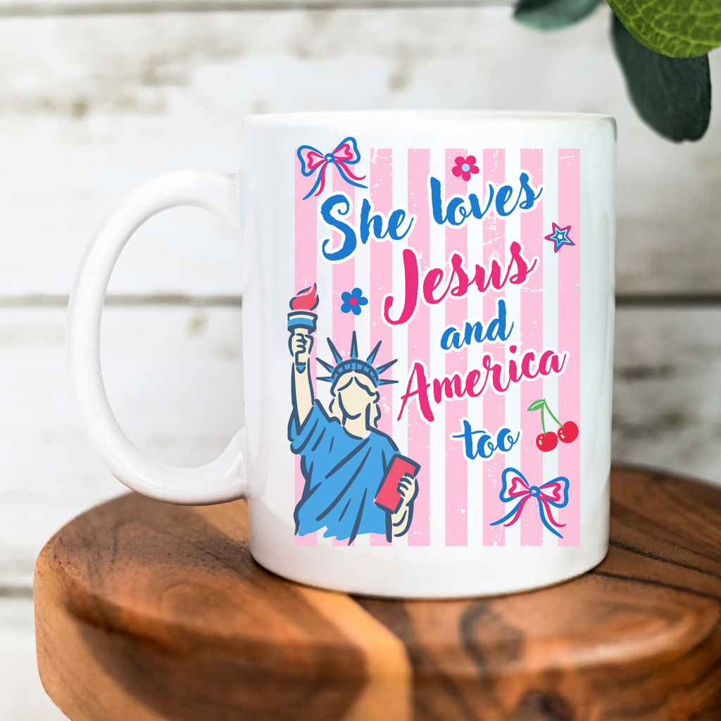 White 11oz. mug with colorful design featuring the Statue of Liberty and text on a wooden surface.