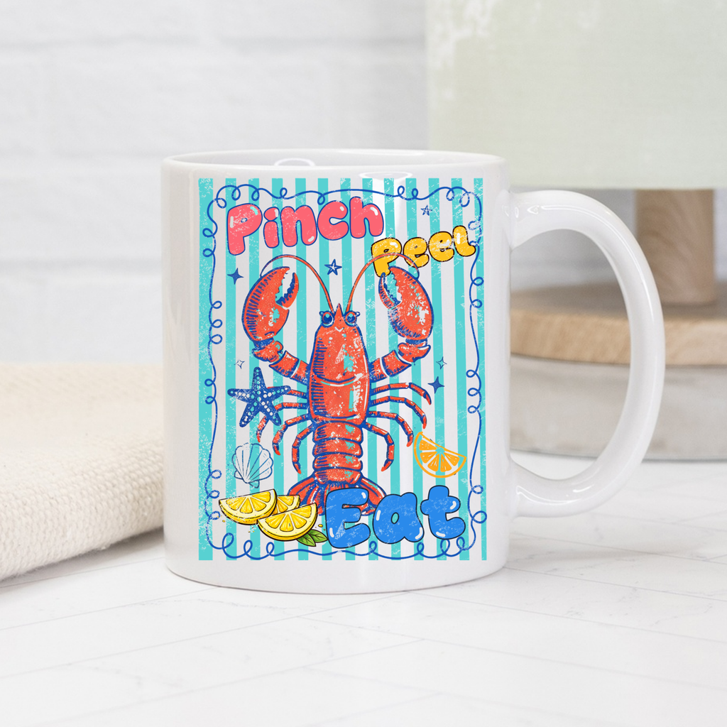 11oz. Mug with a colorful lobster design and text on a white surface