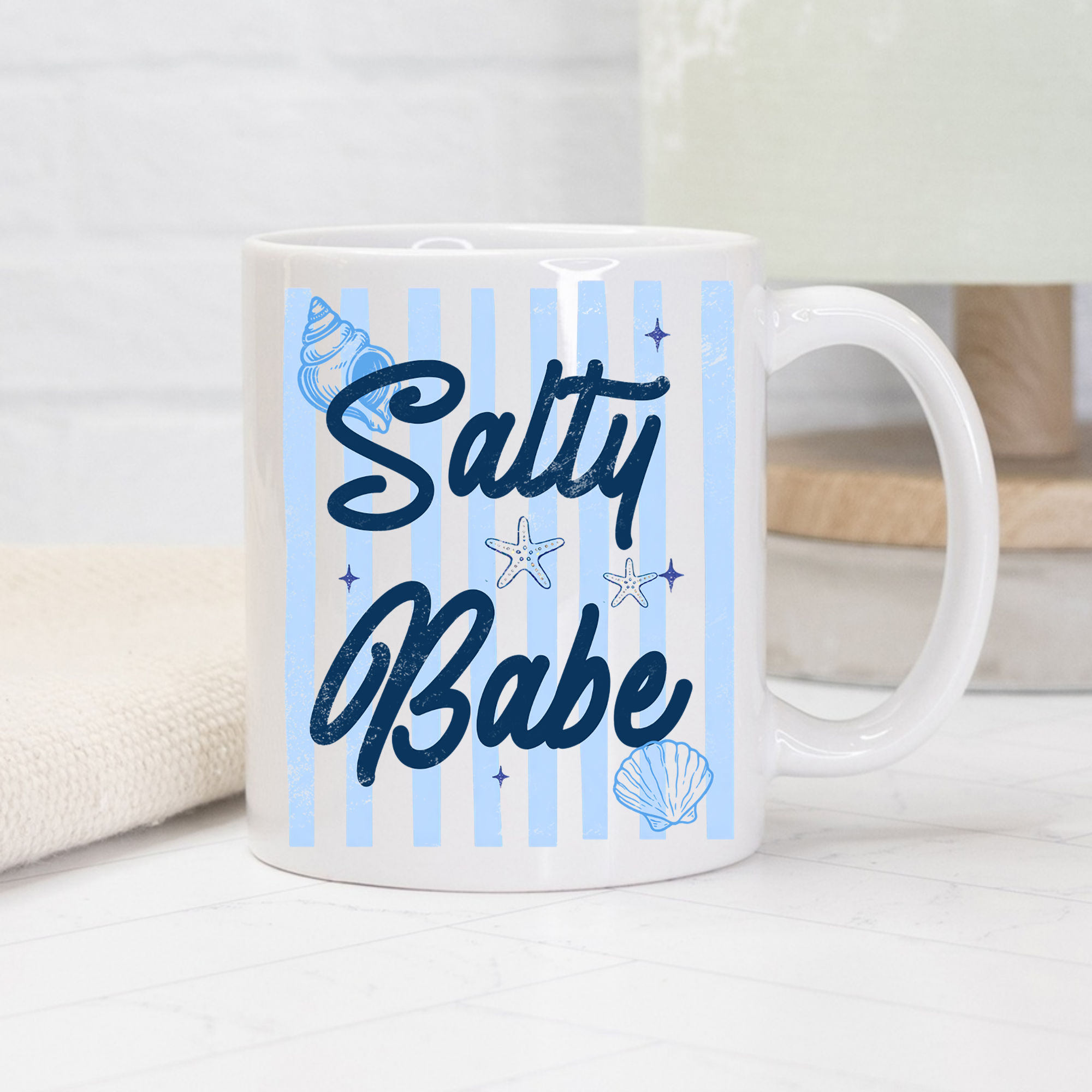 11oz. Mug with 'Salty Babe' text and striped beach-themed design on a light background