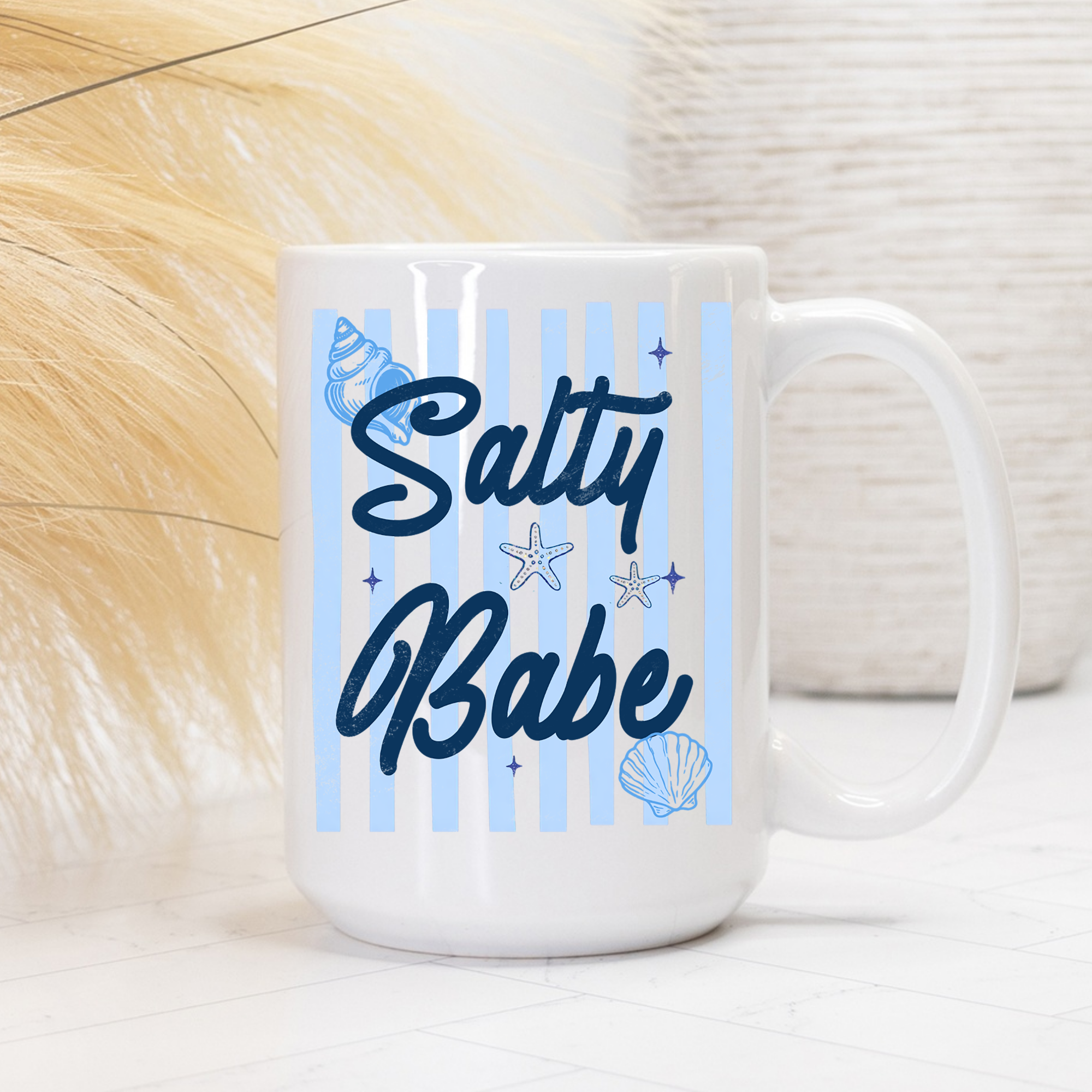 White 15oz. mug with 'Salty Babe' text and striped sea-themed graphics on a light background