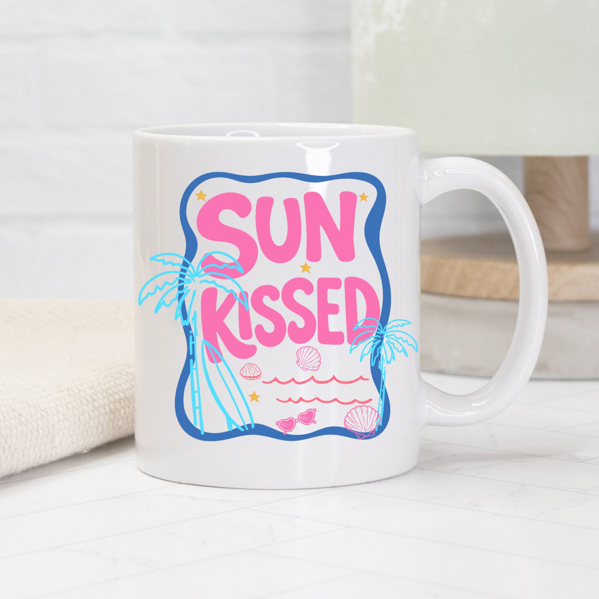 White 11oz. mug with 'Sun Kissed' design featuring palm trees and shells on a white background.