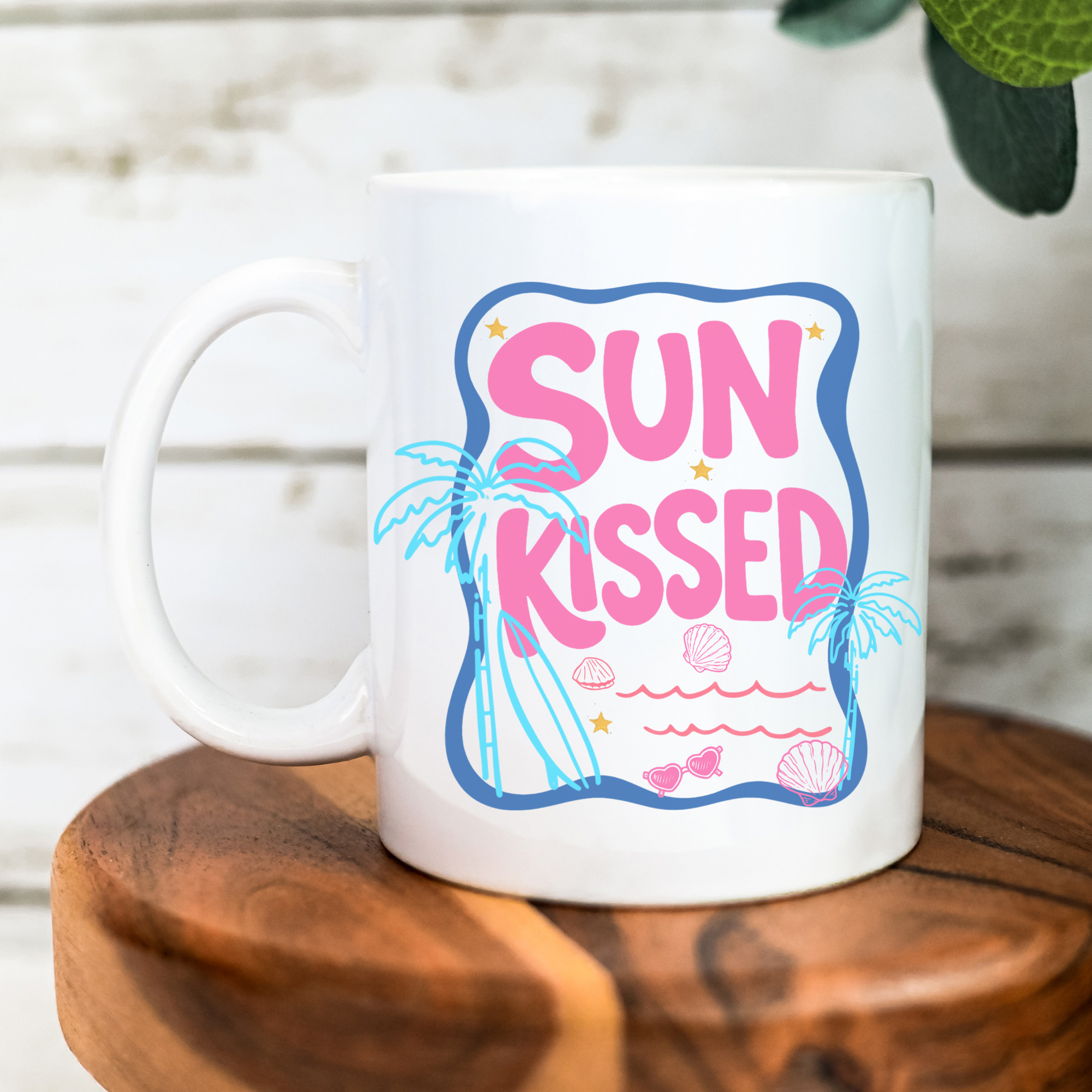 White 11oz. mug with 'Sun Kissed' design on a wooden surface