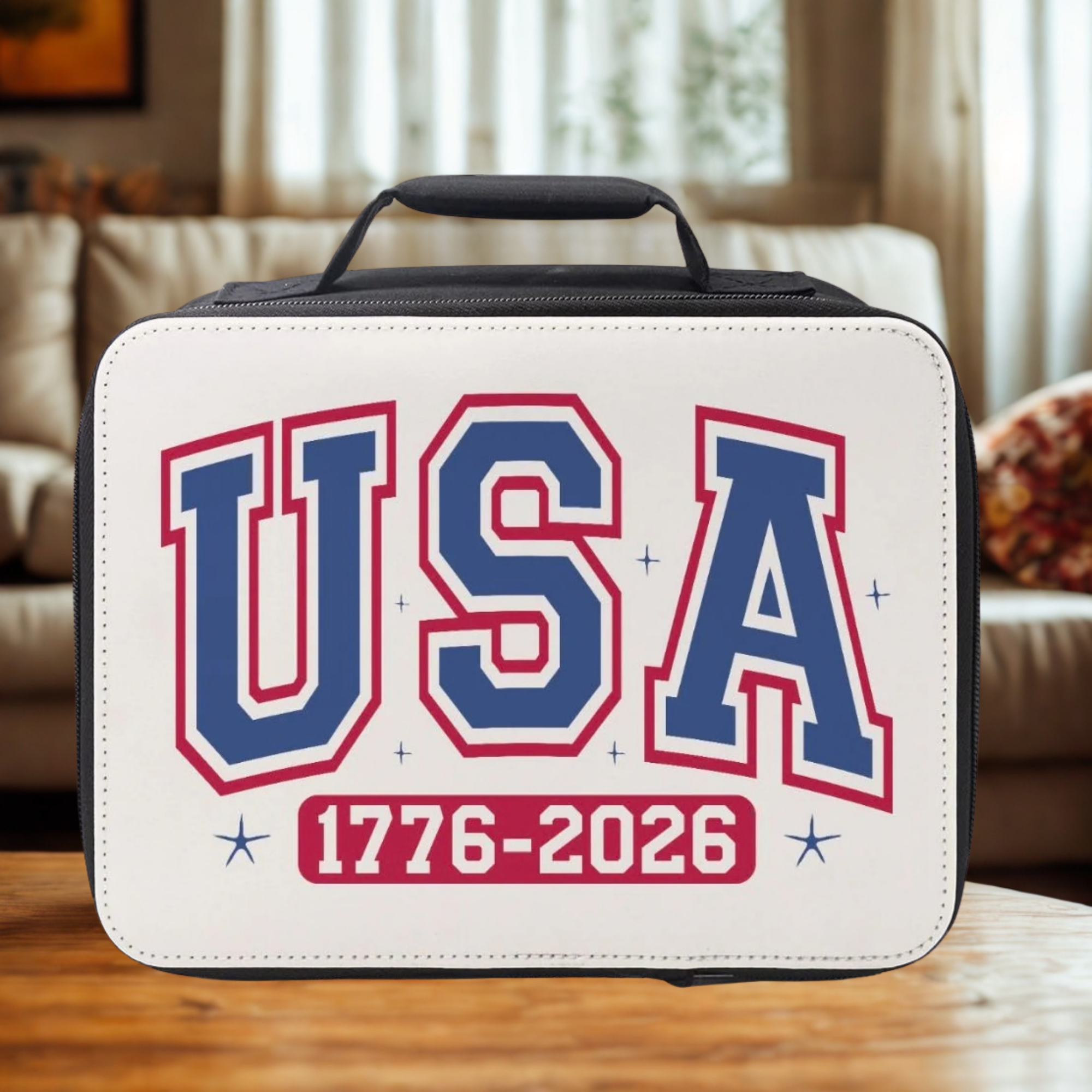 Lunch box with 'USA 1776-2026' text on a wooden coffee table in a cozy living room.