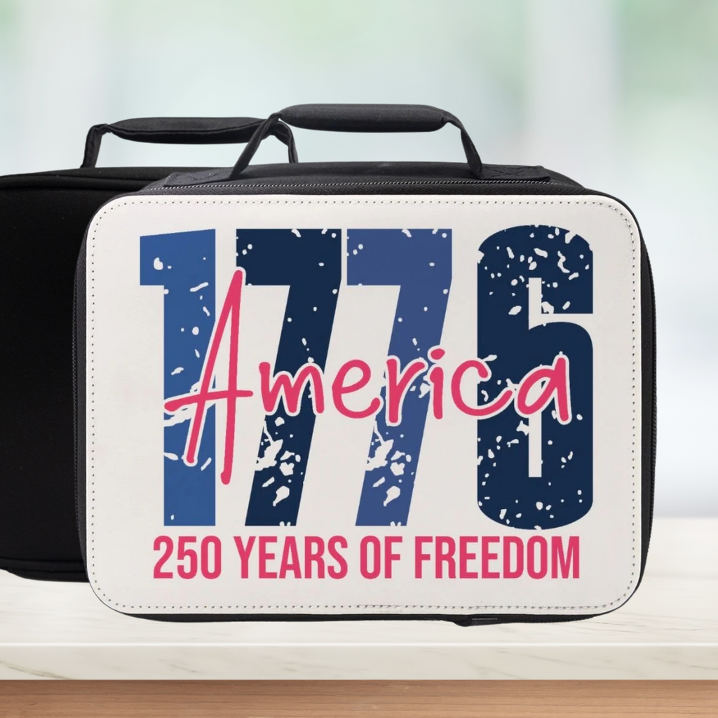 Black and white lunch box with '1776 America 250 Years of Freedom' text on a blurred background