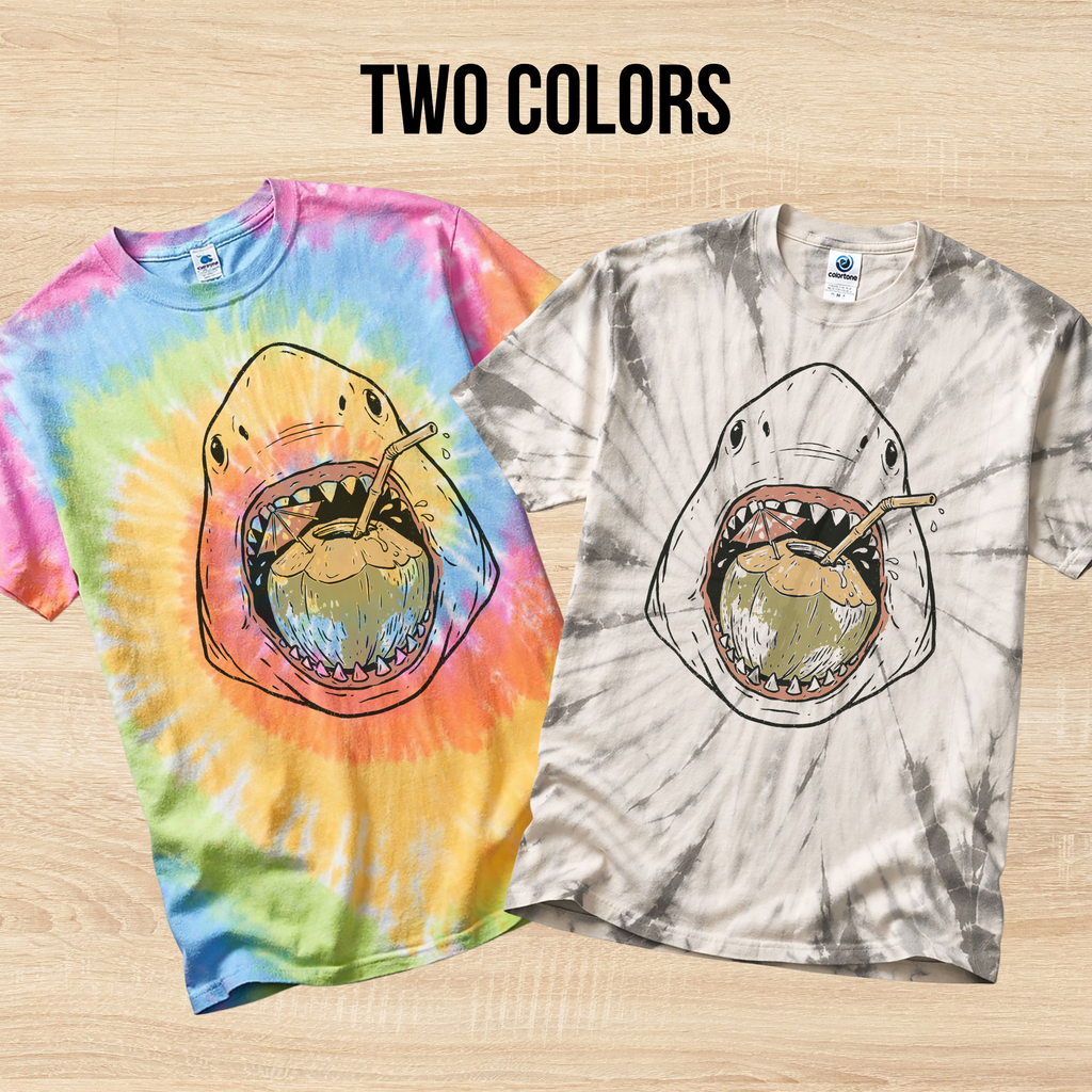 Two tie-dye t-shirts in the colors Eternity on the left and Spider Silver on the right with shark designs on a wooden surface.