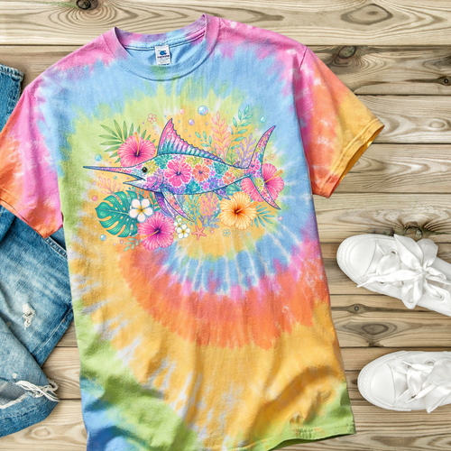 Colorful tie-dye t-shirt with a Swordfish and floral design on a wooden surface.
