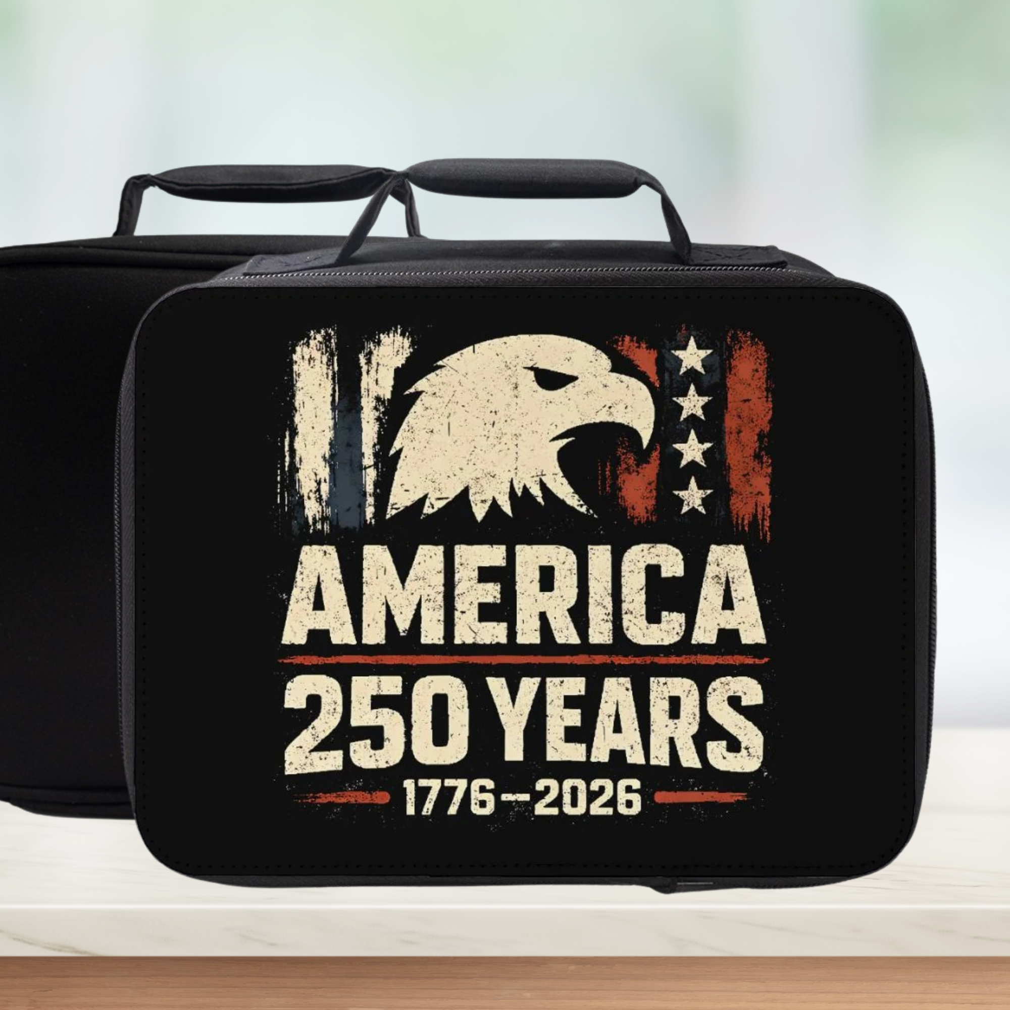 Black lunch bag with American eagle design and 'America 250 Years' text on a blurred background