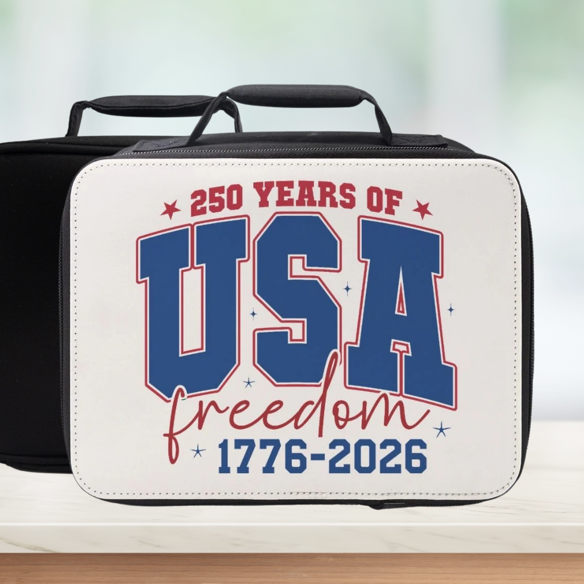 Insulated lunch bag with '250 Years of USA Freedom 1776-2026' text on a blurred background
