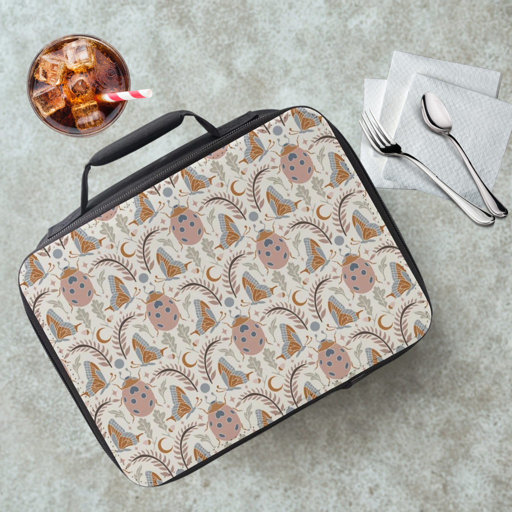 Insect patterned lunch bag on a cafeteria table with a drink and utensils in the background