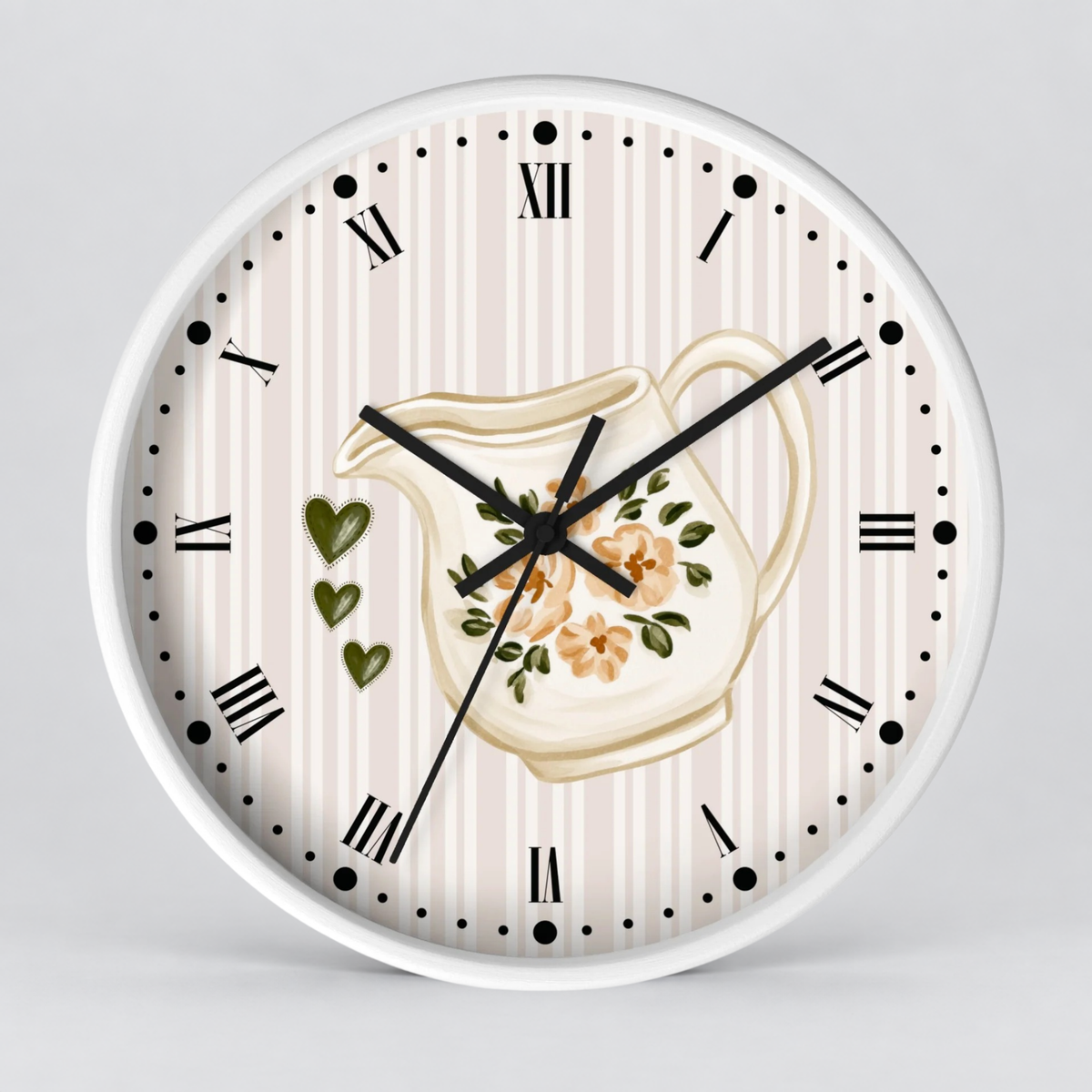 A round wall clock with a white frame and a decorative face featuring vertical cream and light pink stripes, black Roman numerals, black hour and minute hands, and a central illustration of a cream pitcher with orange flowers and green leaves.