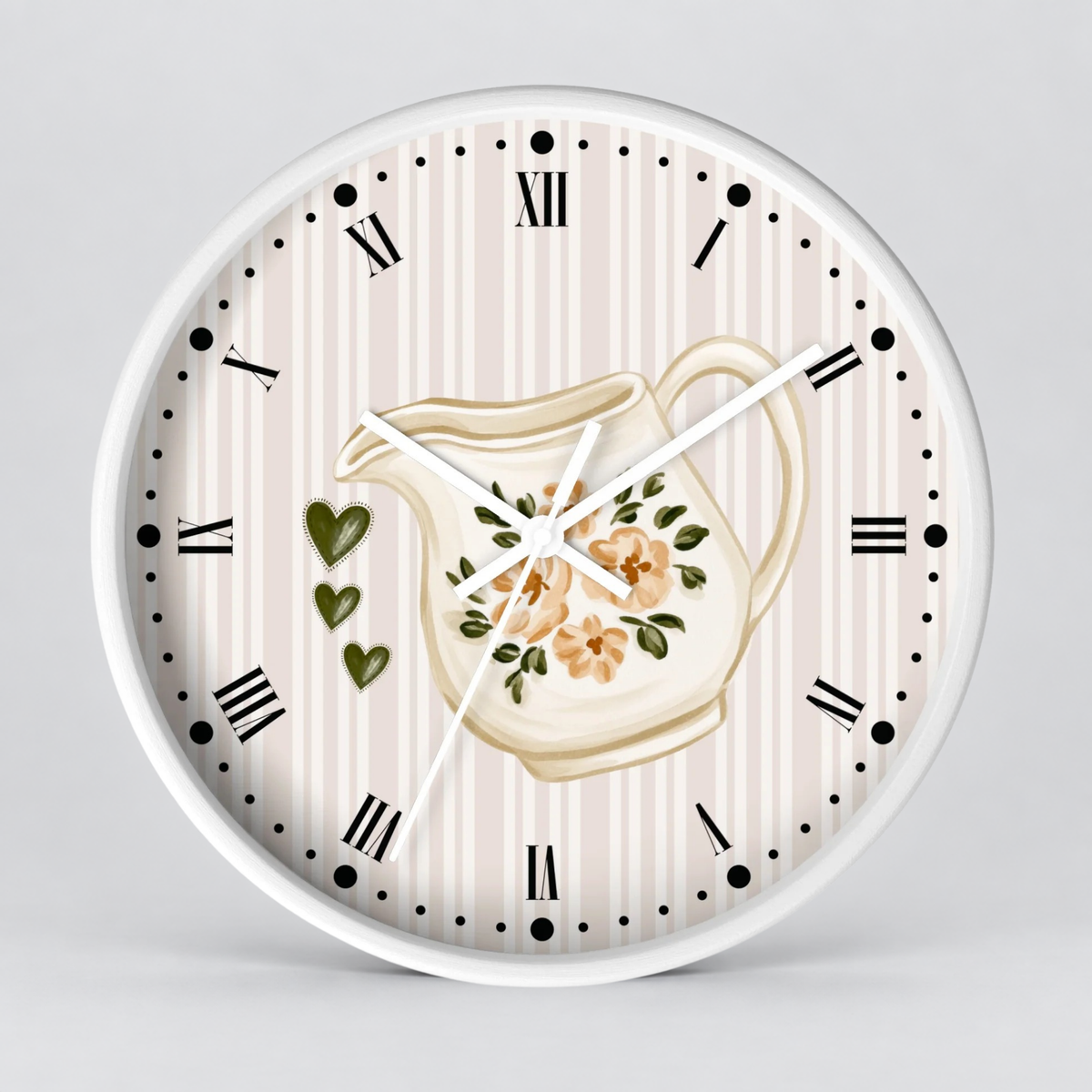 Round wall clock with a white frame and a cream and beige vertically striped dial. The center features an illustration of a floral cream pitcher, with three green hearts on the left side.