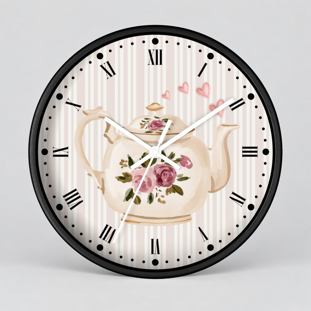 Round wall clock with a black frame, Roman numerals, and a vintage-style floral teapot illustration on a cream and pink striped face, shown against a light gray background.