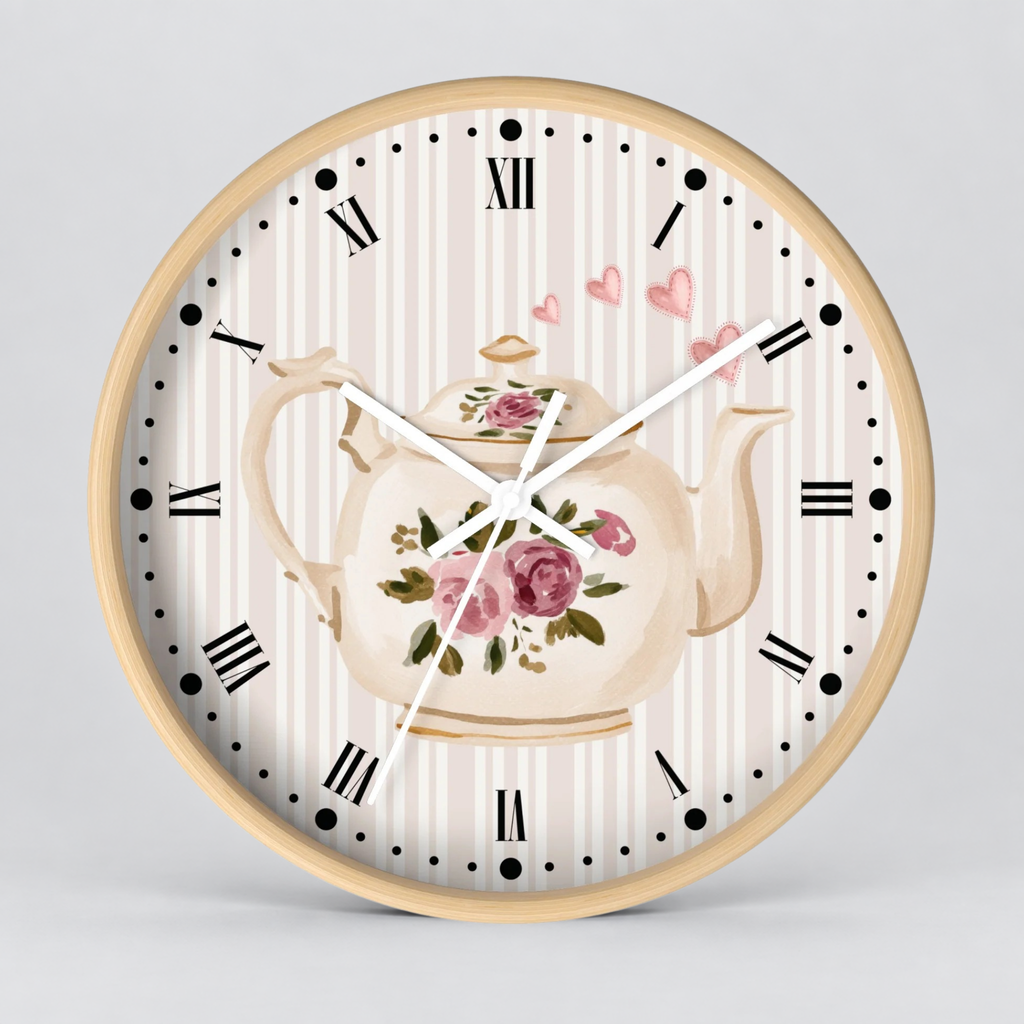 Round wall clock with a light wood frame, featuring a cream and pink floral teapot illustration over a white and beige striped dial with black Roman numerals and white hands.
