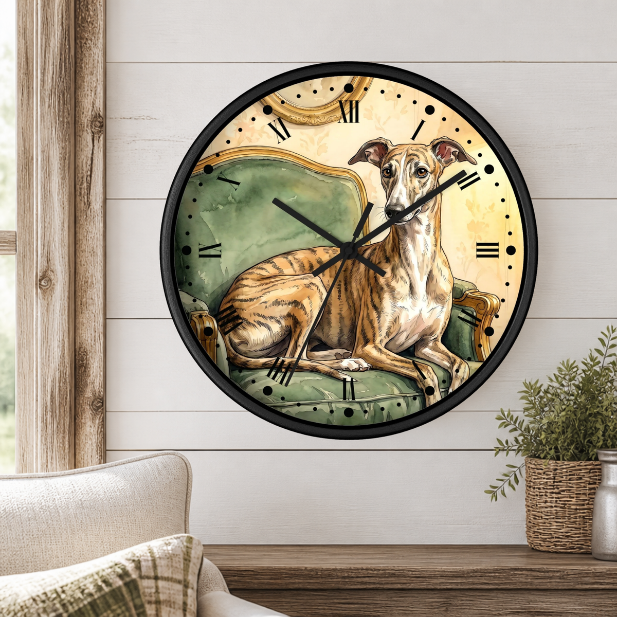 A round wall clock with a black frame and Roman numerals, featuring an illustration of a light brown dog lying on a green chaise lounge. The clock is mounted on a white shiplap wall above a wooden mantel with a small potted plant.