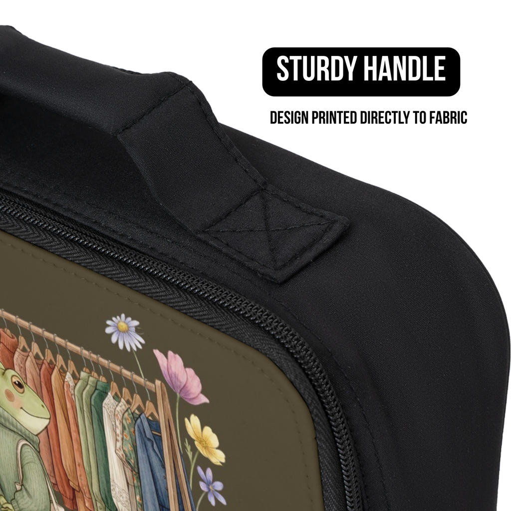 Black lunch bag with a design of a frog, clothes on a rack, and flowers, featuring a sturdy handle.