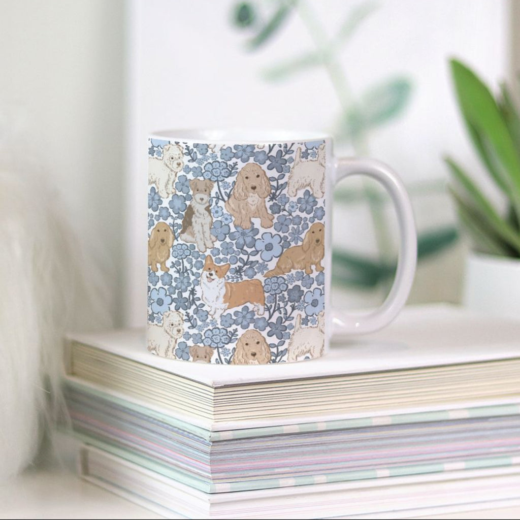 11oz Mug with a hand drawn dog and flower pattern on a stack of books with plants in the background