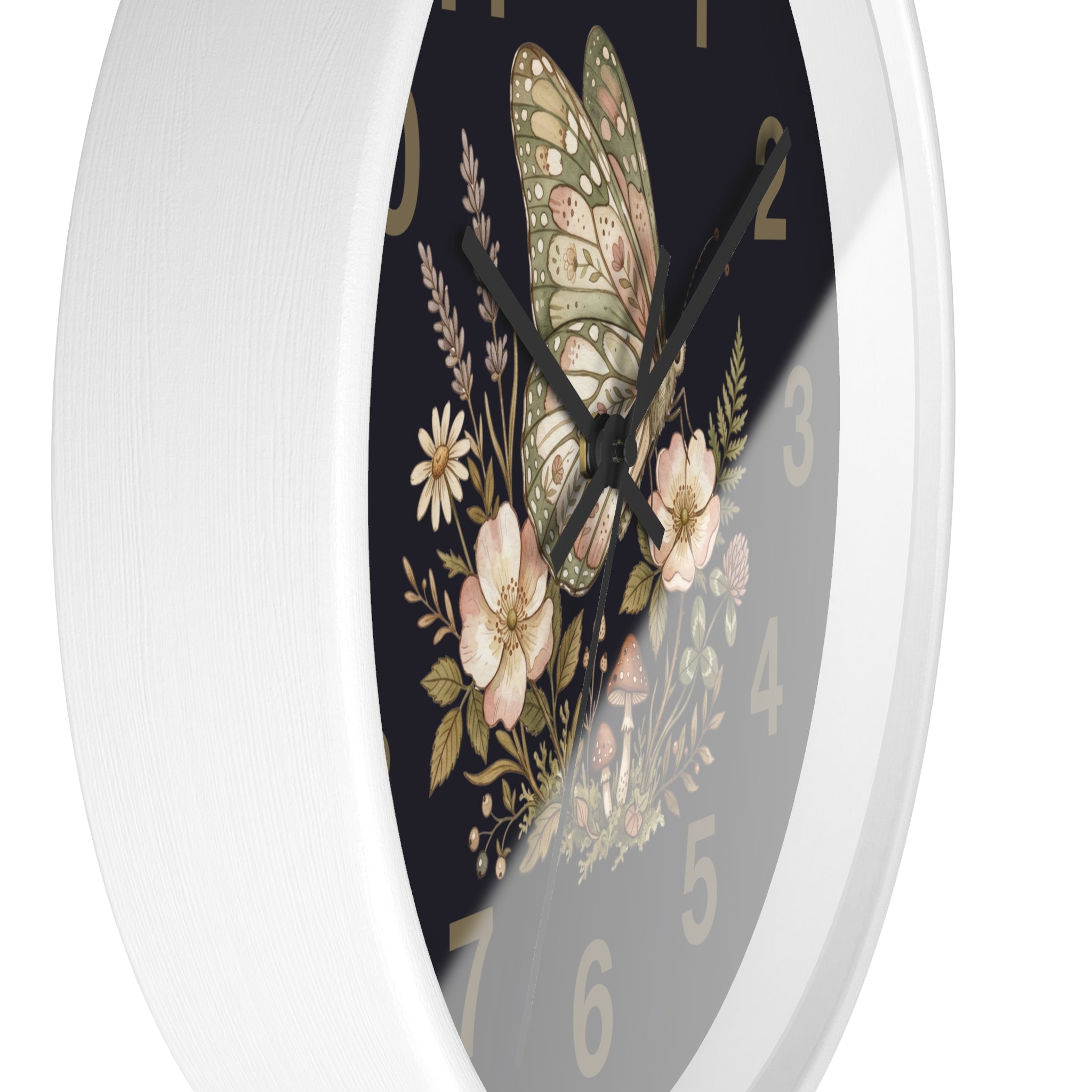 Side view of a round white decorative wall clock with floral and butterfly design on a black background