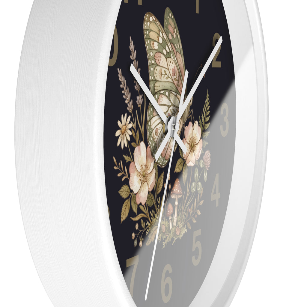 Side view of a decorative round white wall clock with matching white hands and floral butterfly design on a black background