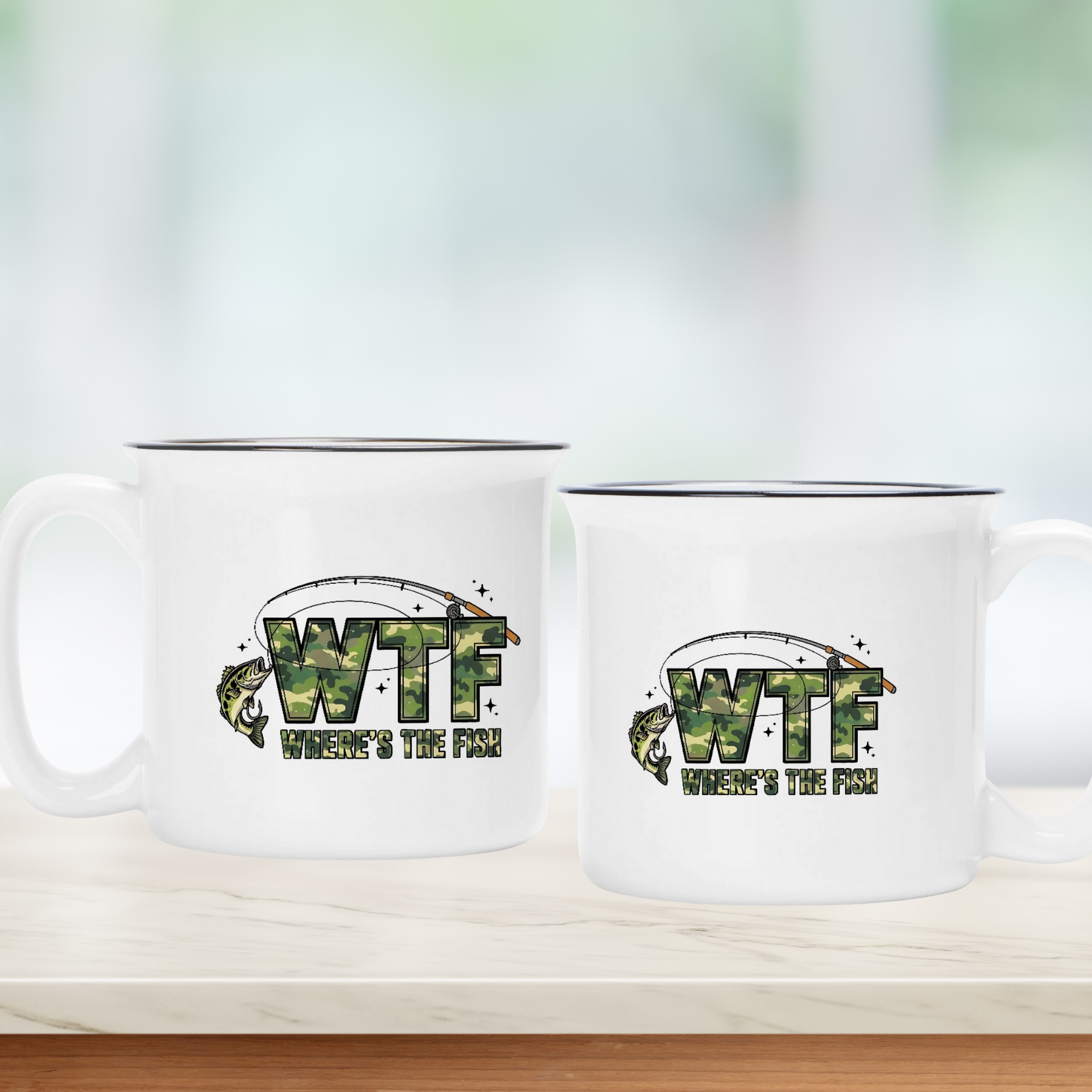 Two white mugs with 'WTF Where's the Fish?' text design on a wooden surface.