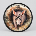 Round wall clock with a black frame and a watercolor-style illustration of an anteater emerging from a hole at the center. The clock face has black numerals and black hands, shown against a light gray background.