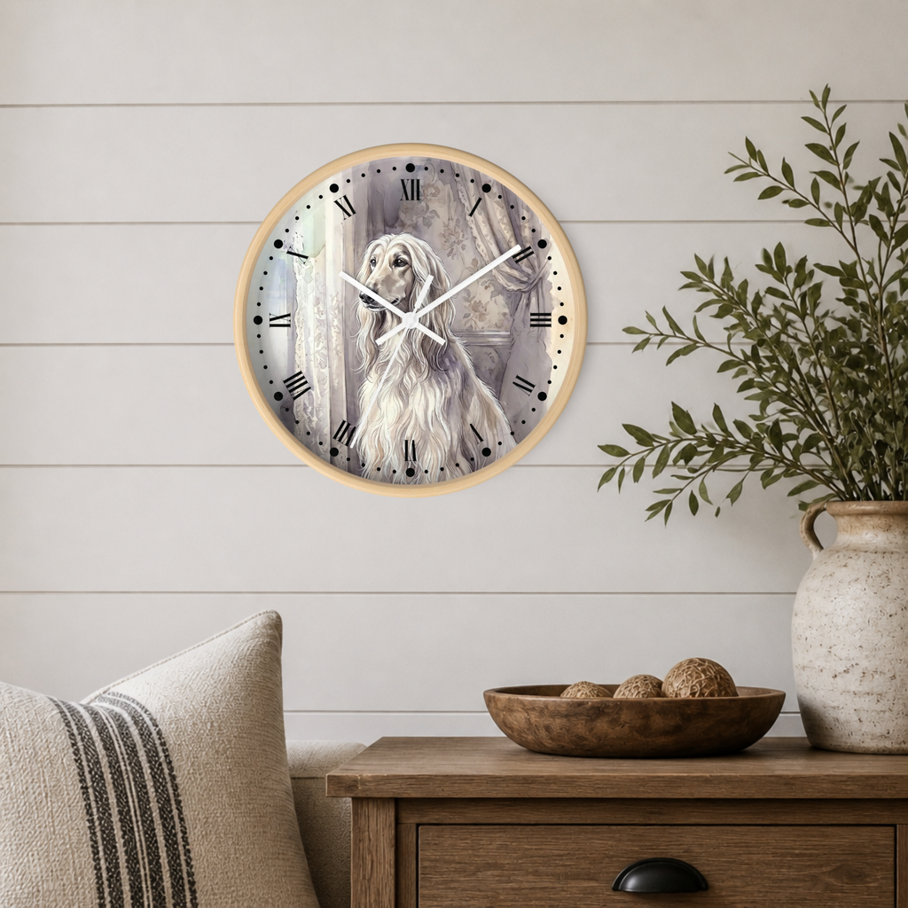 A round wall clock with a light wood frame hangs on a white shiplap wall above a wooden side table. The clock face features a detailed illustration of a long-haired white dog, with black Roman numerals and white hands.