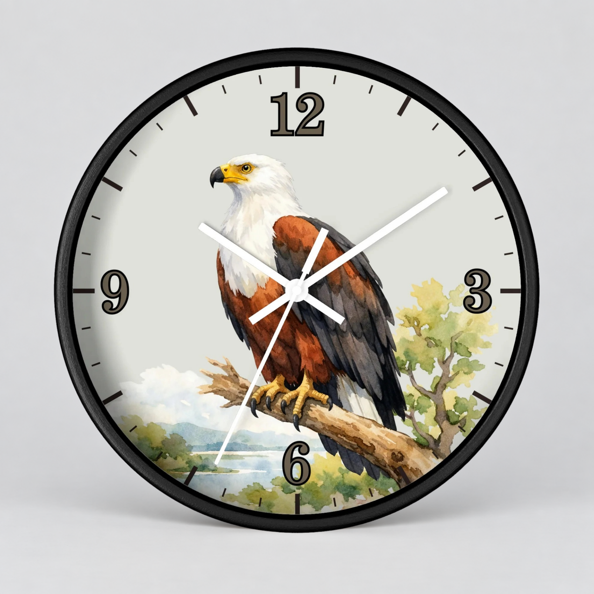 A round wall clock with a black frame and a printed eagle illustration on the face. The clock has black Arabic numerals and white hands, photographed against a light gray studio background.